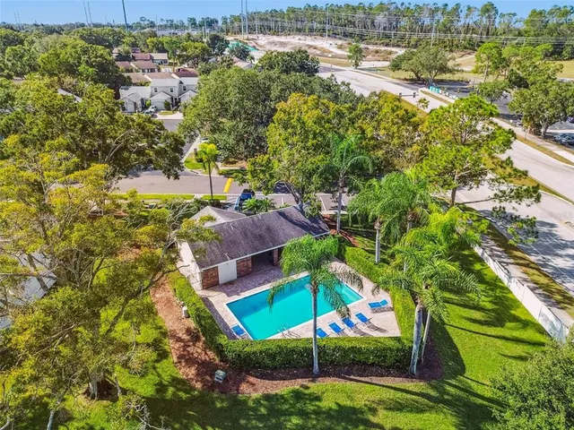an aerial view of residential houses with outdoor space and swimming pool