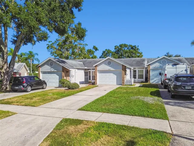 a front view of a house with a garden and yard
