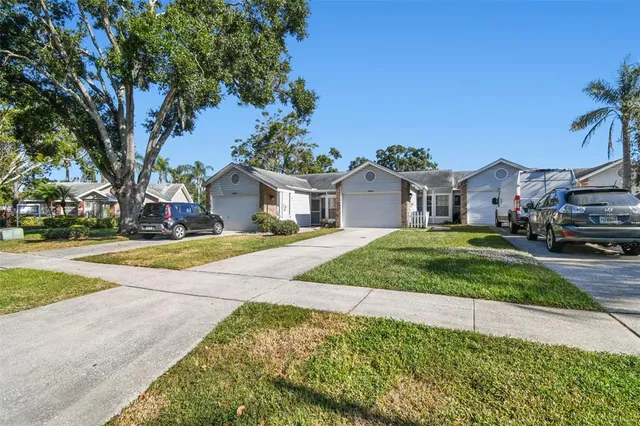 a view of an house with backyard and tree