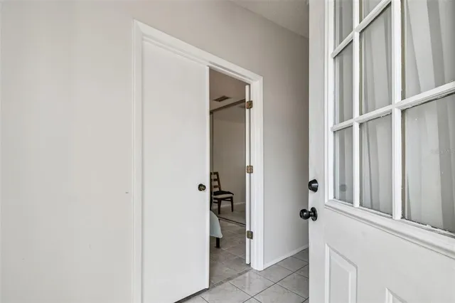 a view of a hallway with closet and a bathroom