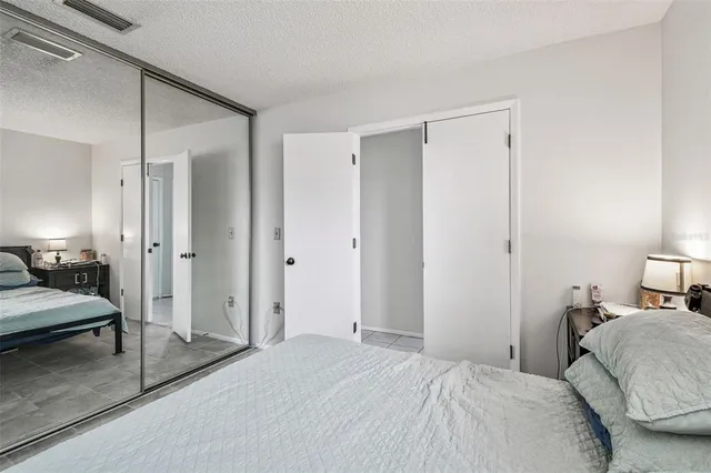 a bedroom with a bed and a lamp