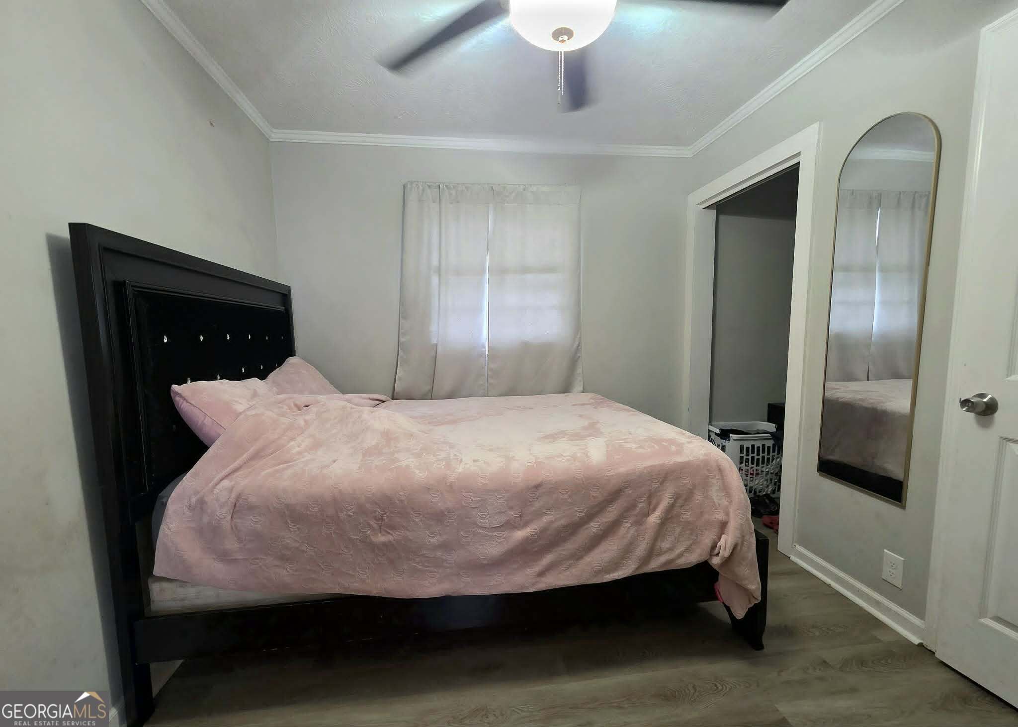 119 O Street Southwest Thomaston, GA 30286 - Photo 7 of 9 a bed sitting in a bedroom and a mirror