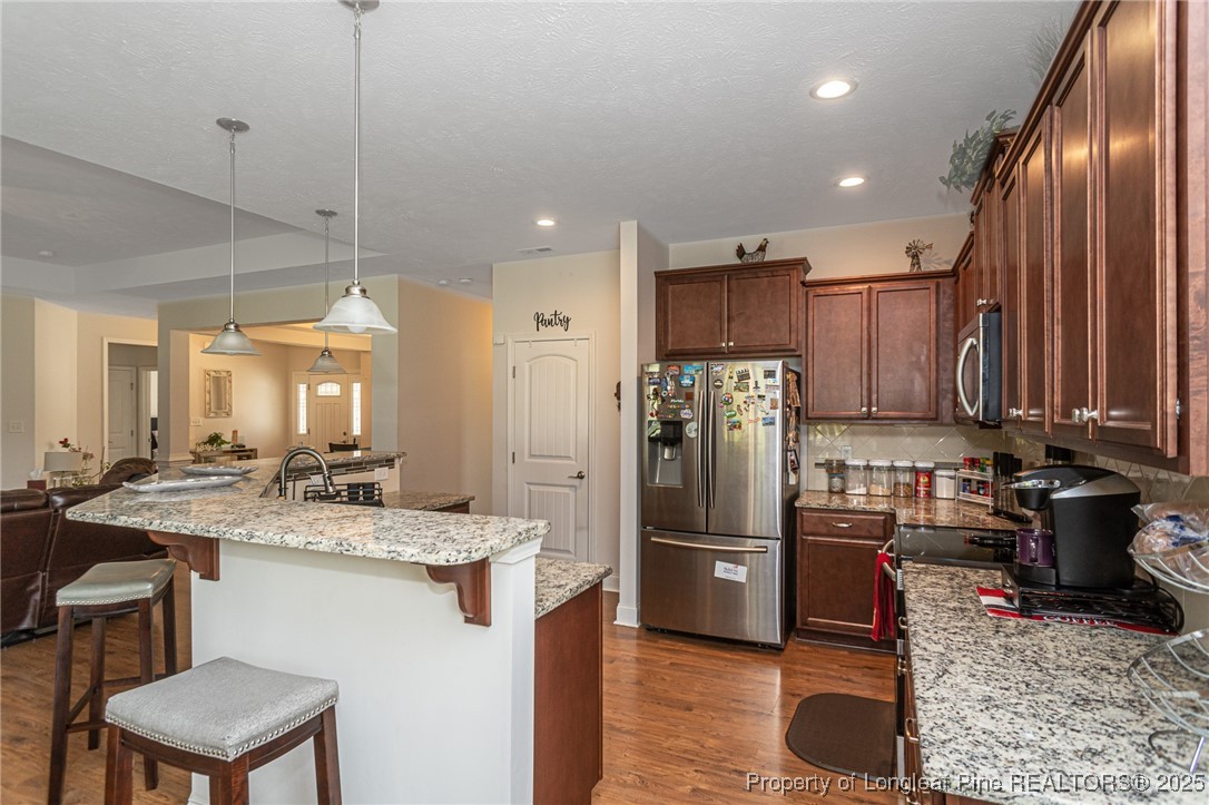 8220 Rivermist Lane Linden, NC 28356 - Photo 11 of 44 a kitchen with a refrigerator and a sink