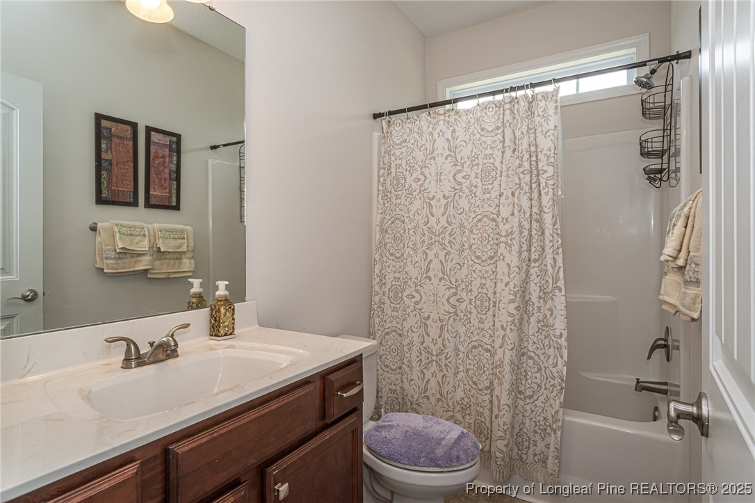 8220 Rivermist Lane Linden, NC 28356 - Photo 16 of 44 a bathroom with a sink a toilet and shower