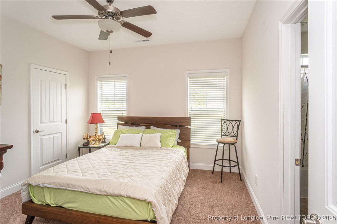 8220 Rivermist Lane Linden, NC 28356 - Photo 17 of 44 a bedroom with a bed and window