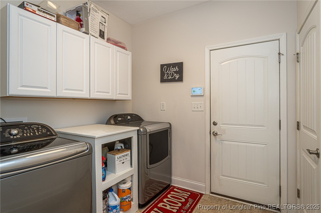 8220 Rivermist Lane Linden, NC 28356 - Photo 19 of 44 a view of storage and utility room with washer and dryer