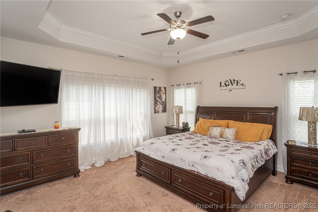 8220 Rivermist Lane Linden, NC 28356 - Photo 21 of 44 a bedroom with a bed a window and a flat screen television