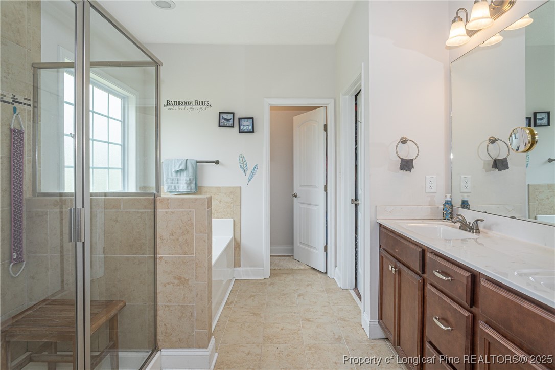 8220 Rivermist Lane Linden, NC 28356 - Photo 25 of 44 a spacious bathroom with a shower sink and mirror