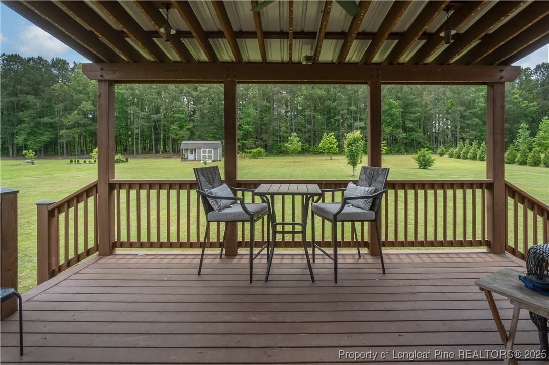 8220 Rivermist Lane Linden, NC 28356 - Photo 38 of 44 a view of a chairs and table in patio with wooden floor