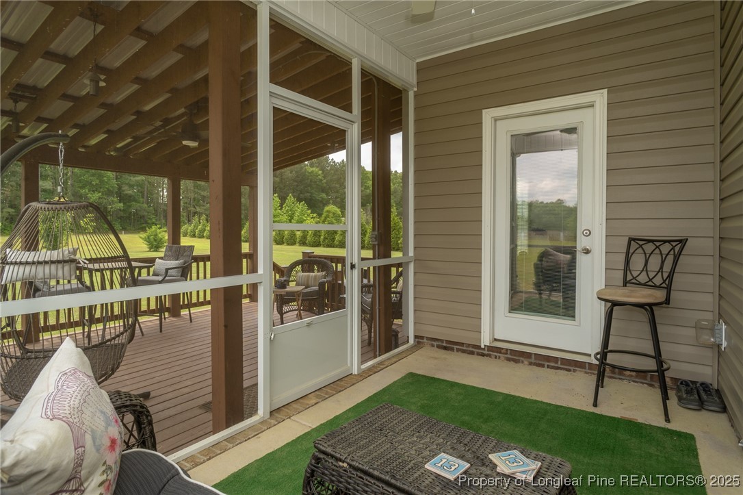 8220 Rivermist Lane Linden, NC 28356 - Photo 39 of 44 a view of a porch with furniture and a yard