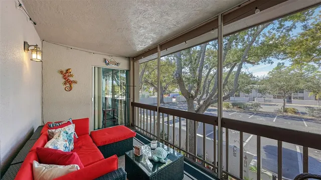 a balcony with furniture and a potted plant