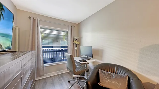 a view of a workspace with furniture and a window