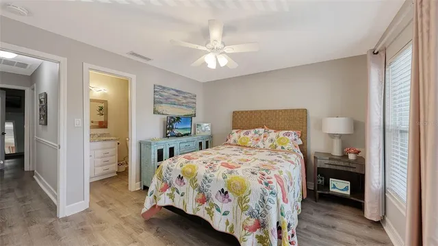 a bedroom with a bed and a tv on table