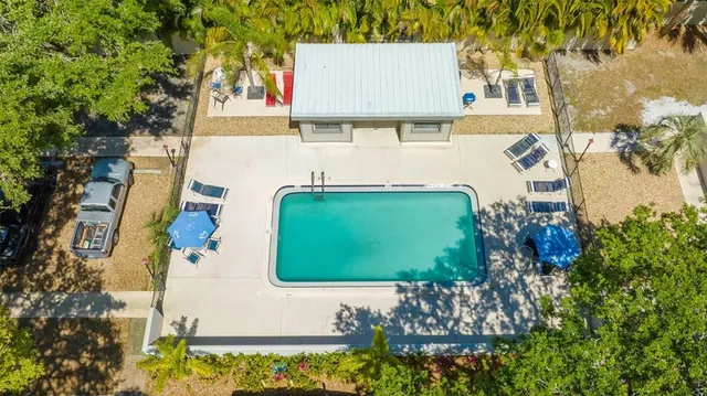 an aerial view of a house with a yard