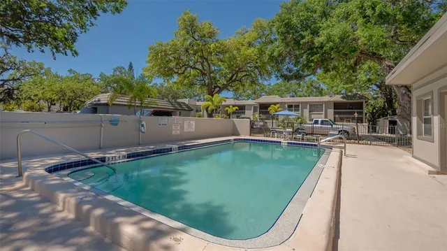 a view of a house with pool and sitting area