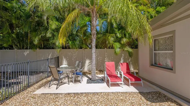 a view of a chairs and table in the patio