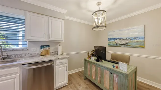 a kitchen with stainless steel appliances granite countertop a stove and a white cabinets