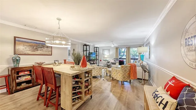 a view of a dining room with furniture window and wooden floor