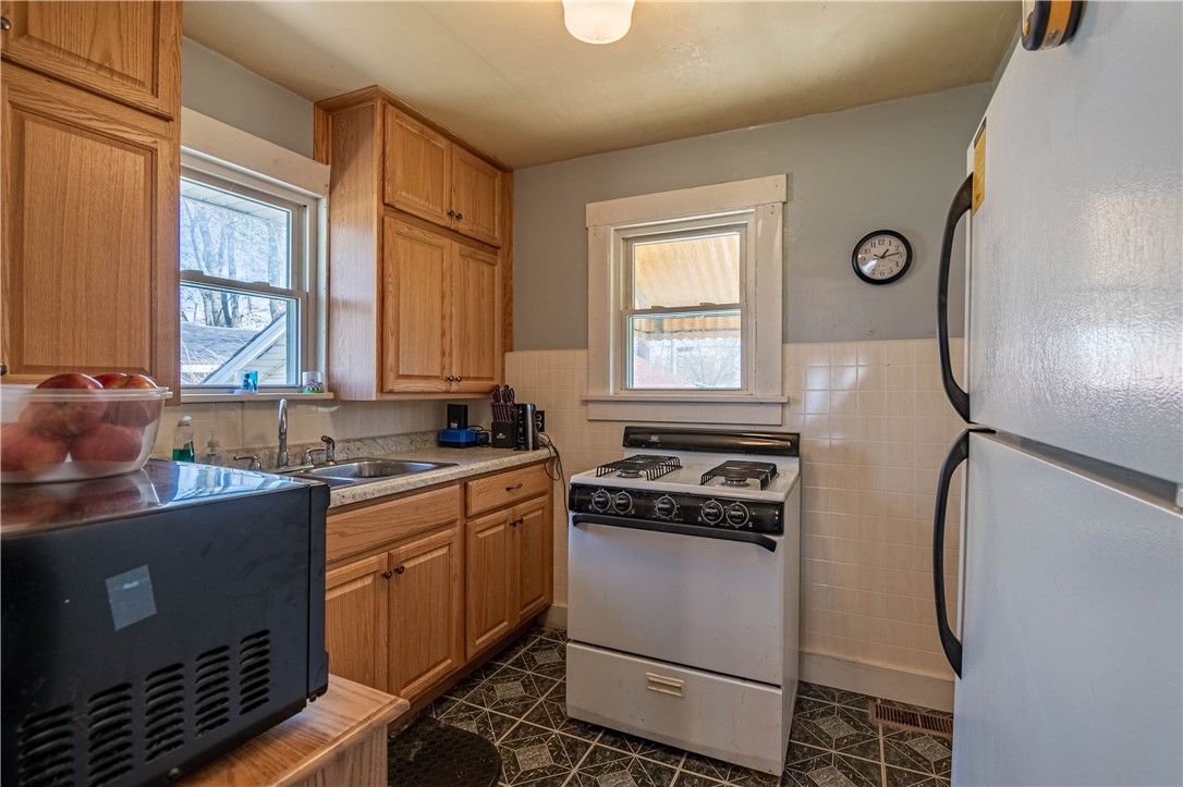 514 South 22nd Street Decatur, IL 62521 - Photo 6 of 15 a kitchen with a sink a stove cabinets and a window
