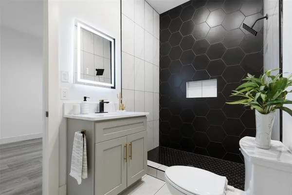 a bathroom with a sink toilet and shower