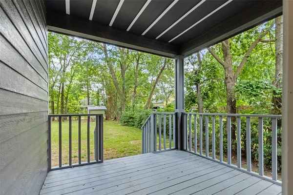 a view of balcony with wooden floor