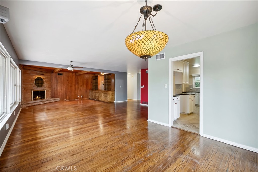 4254 Miramonte Place Riverside, CA 92501 - Photo 11 of 43 a view of a room with wooden floor and chandelier