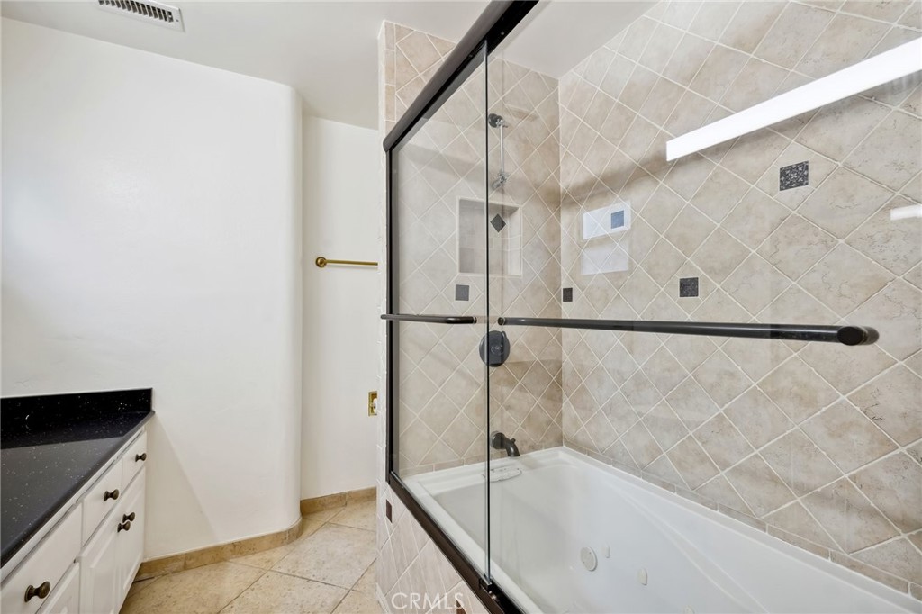 4254 Miramonte Place Riverside, CA 92501 - Photo 20 of 43 a bathroom with a bathtub and a shower