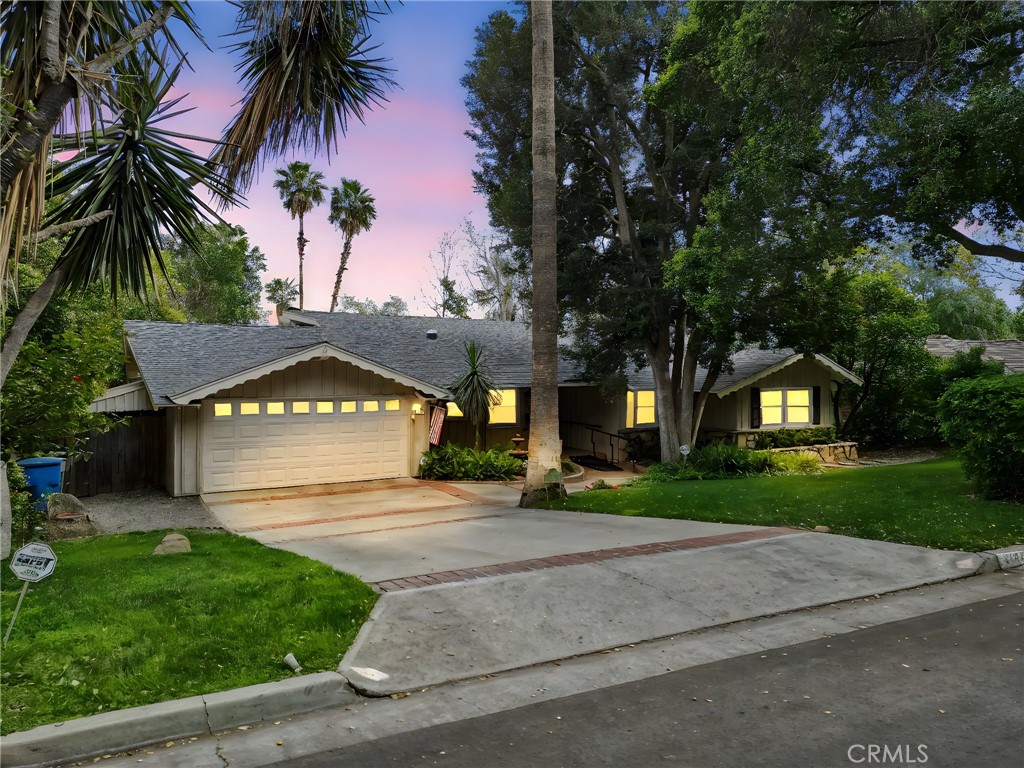 4254 Miramonte Place Riverside, CA 92501 - Photo 2 of 43 a front view of a house with a garden and trees