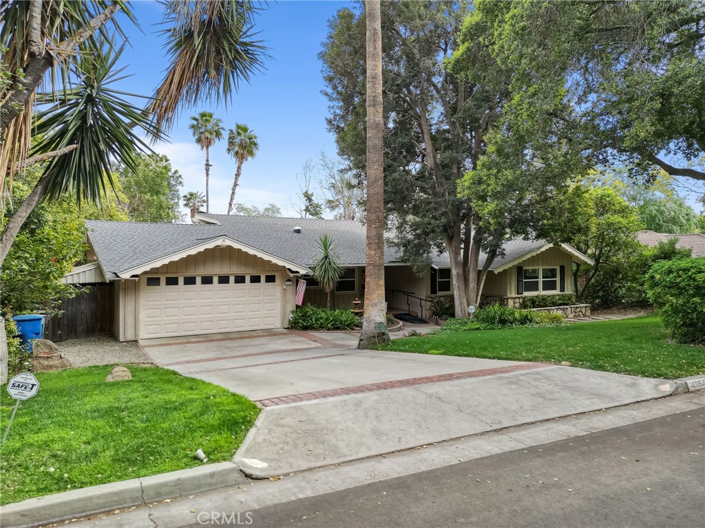 4254 Miramonte Place Riverside, CA 92501 - Photo 3 of 43 a front view of a house with a garden and trees