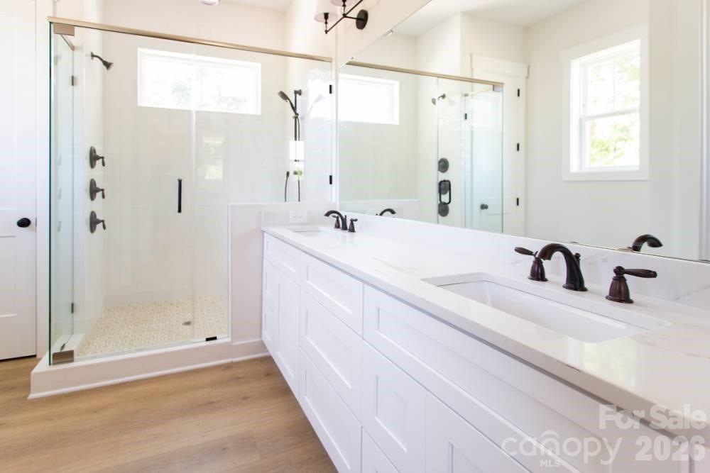 1 Antioch Church Road Weddington, NC 28104 - Photo 11 of 22 a bathroom with a double vanity sink mirror and shower