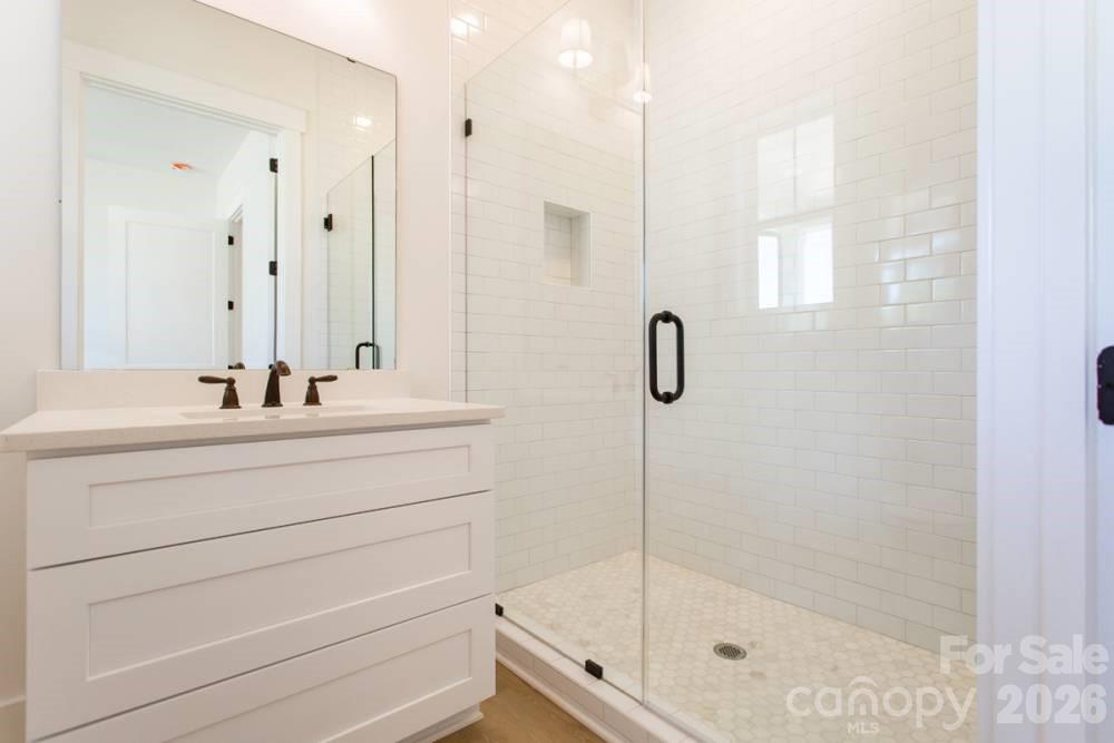 1 Antioch Church Road Weddington, NC 28104 - Photo 20 of 22 a bathroom with a shower sink and mirror