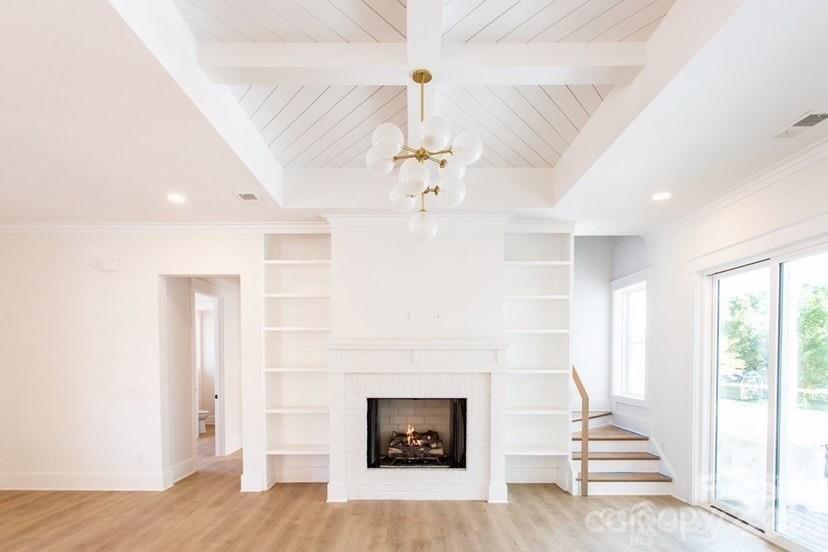 1 Antioch Church Road Weddington, NC 28104 - Photo 2 of 22 a living room with a fireplace and chandelier
