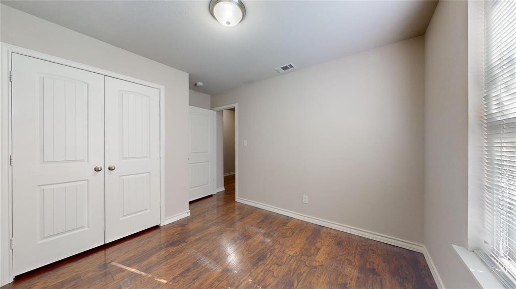 2104 Daniel Street Fort Worth, TX 76104 - Photo 7 of 12 Unfurnished bedroom with dark wood-type flooring and a closet