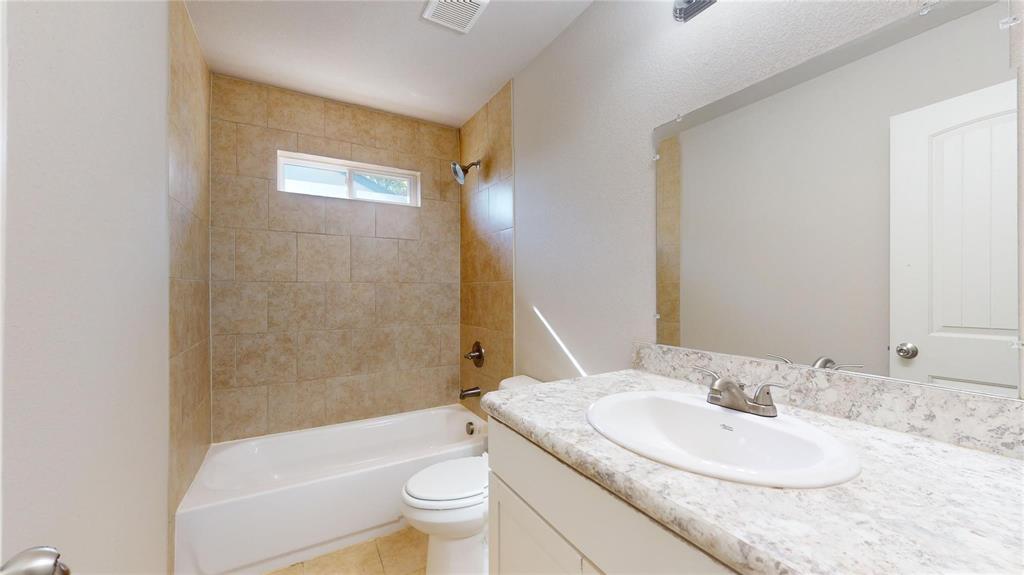 2104 Daniel Street Fort Worth, TX 76104 - Photo 9 of 12 Full bath with vanity, shower / bath combination, and light tile patterned floors