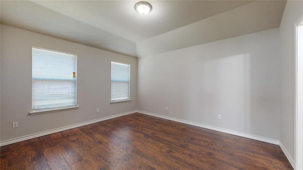 2104 Daniel Street Fort Worth, TX 76104 - Photo 10 of 12 Unfurnished room featuring dark wood-style flooring and vaulted ceiling