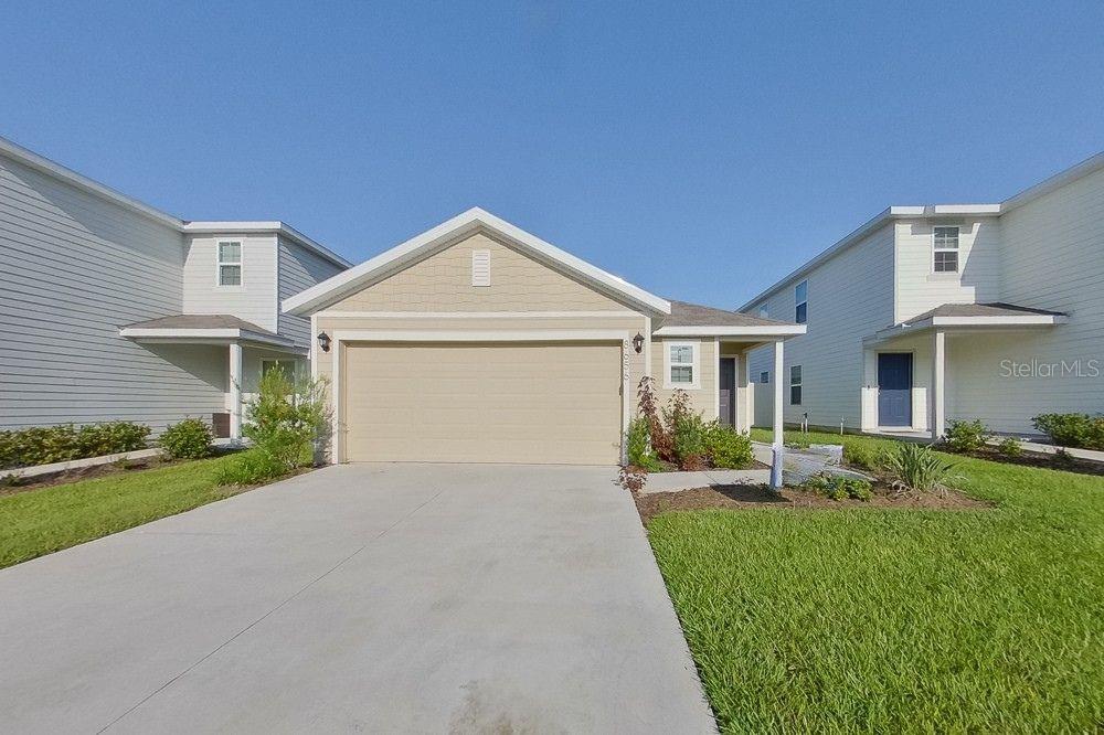 8656 Southwest 44th Court Ocala, FL 34476 - Photo 1 of 19 a front view of a house with a yard and garage