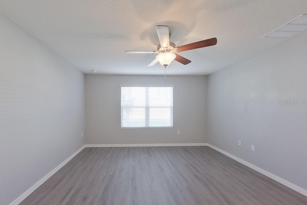8656 Southwest 44th Court Ocala, FL 34476 - Photo 14 of 19 wooden floor in an empty room with a window