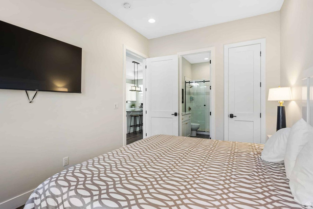 4311 Canterbury Road, Unit F2 Hurricane, UT 84737 - Photo 17 of 18 Interior room featuring recessed lighting, a built-in wall-mounted television, and a white paneled door with black hardware