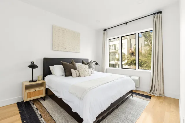 a view of a balcony with a floor to ceiling window and wooden fence