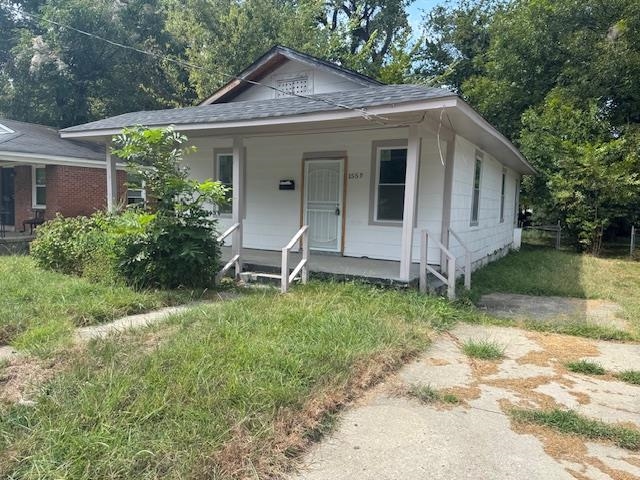1559 Harrison Street Memphis, TN 38108 - Photo 1 of 11 View of front of property featuring a porch and a shingled roof