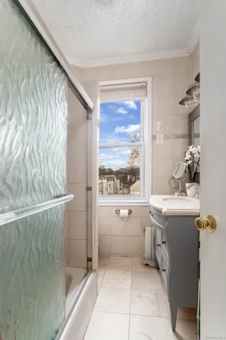 a bathroom with a granite countertop sink a large mirror and a bathtub