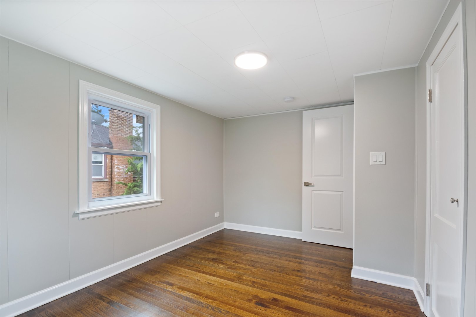 2513 5th Avenue North Riverside, IL 60546 - Photo 22 of 27 a view of an empty room with wooden floor and a window