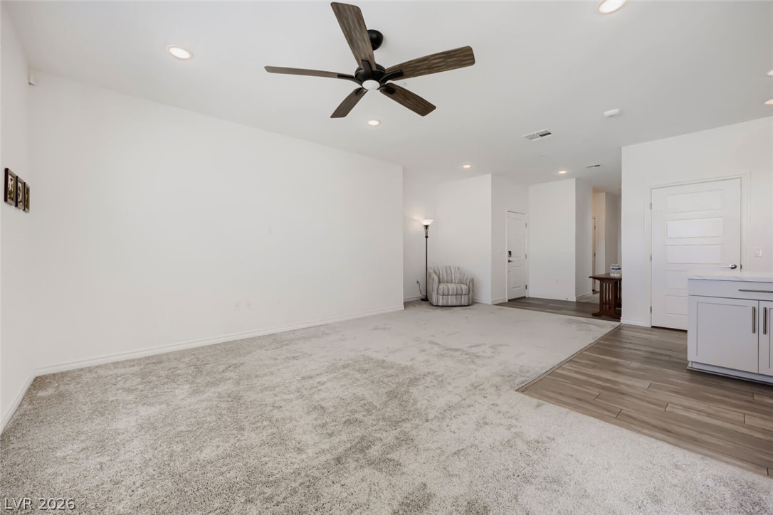 2555 Hampton Road, Unit 9301 Henderson, NV 89052 - Photo 12 of 36 A spacious living area offers plush carpeting, wood-look flooring, and a ceiling fan for comfort.