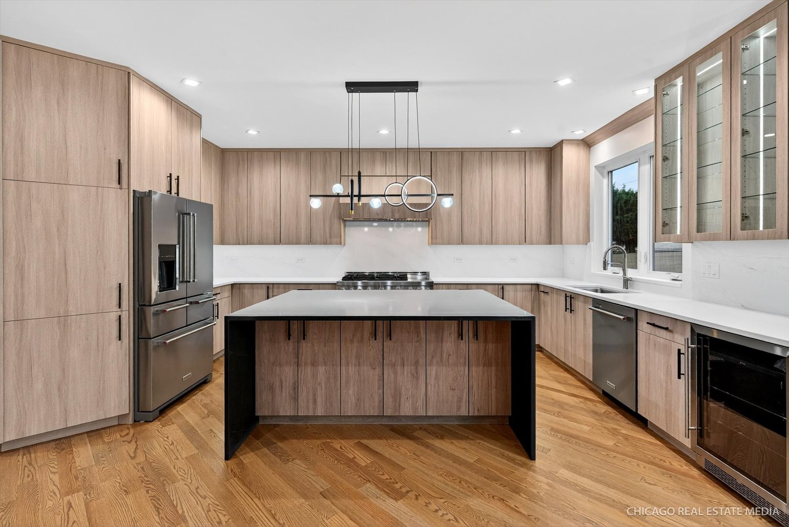 6090 Belmont Road Downers Grove, IL 60516 - Photo 3 of 75 a kitchen with kitchen island wooden floors appliances and cabinets