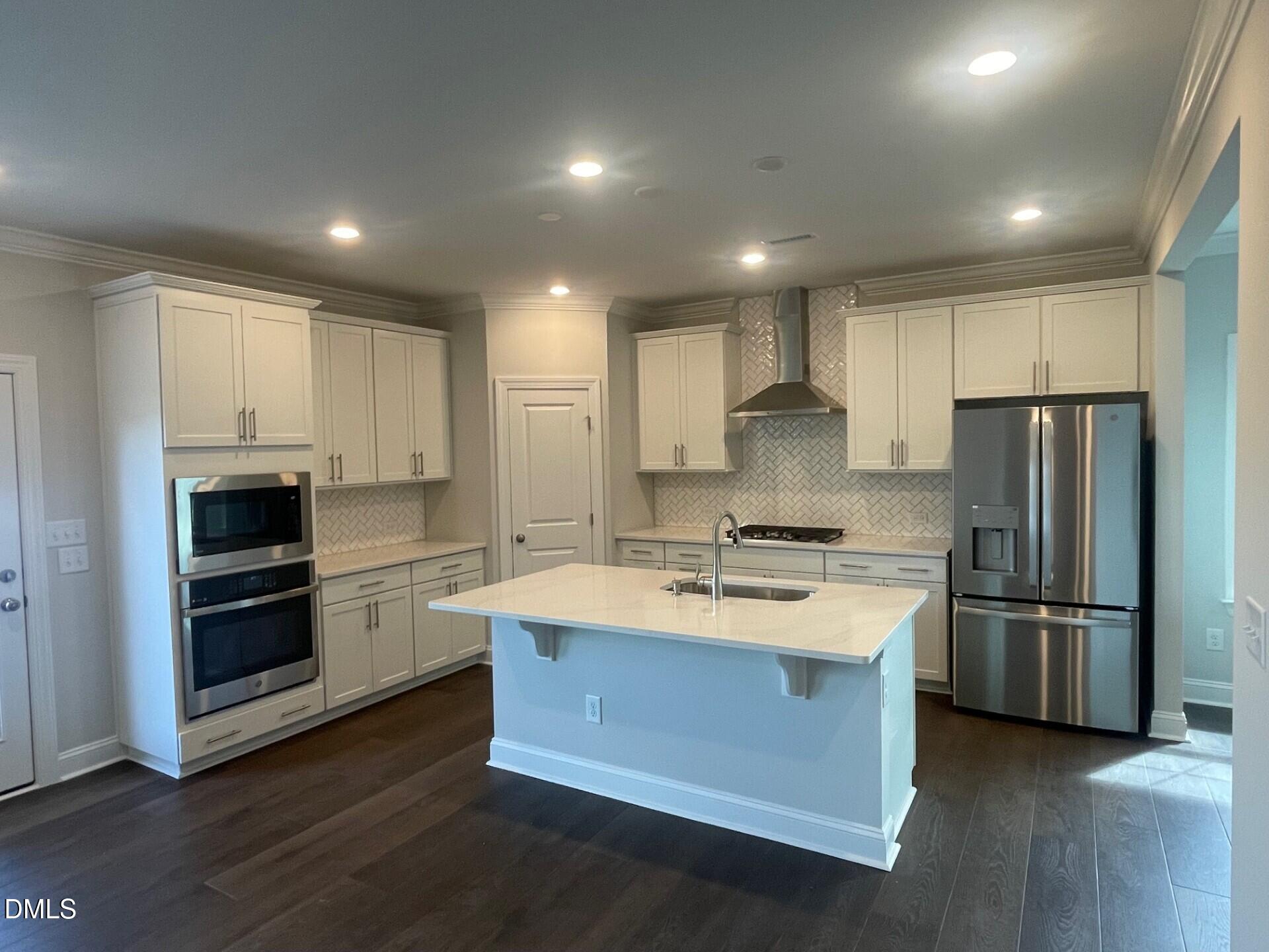 1307 Cosmic Drive Durham, NC 27703 - Photo 4 of 30 a kitchen with refrigerator a microwave and stove