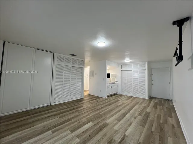 a view of an empty room and wooden floor