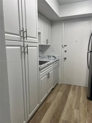 a kitchen with a sink a refrigerator freezer a stove and a refrigerator