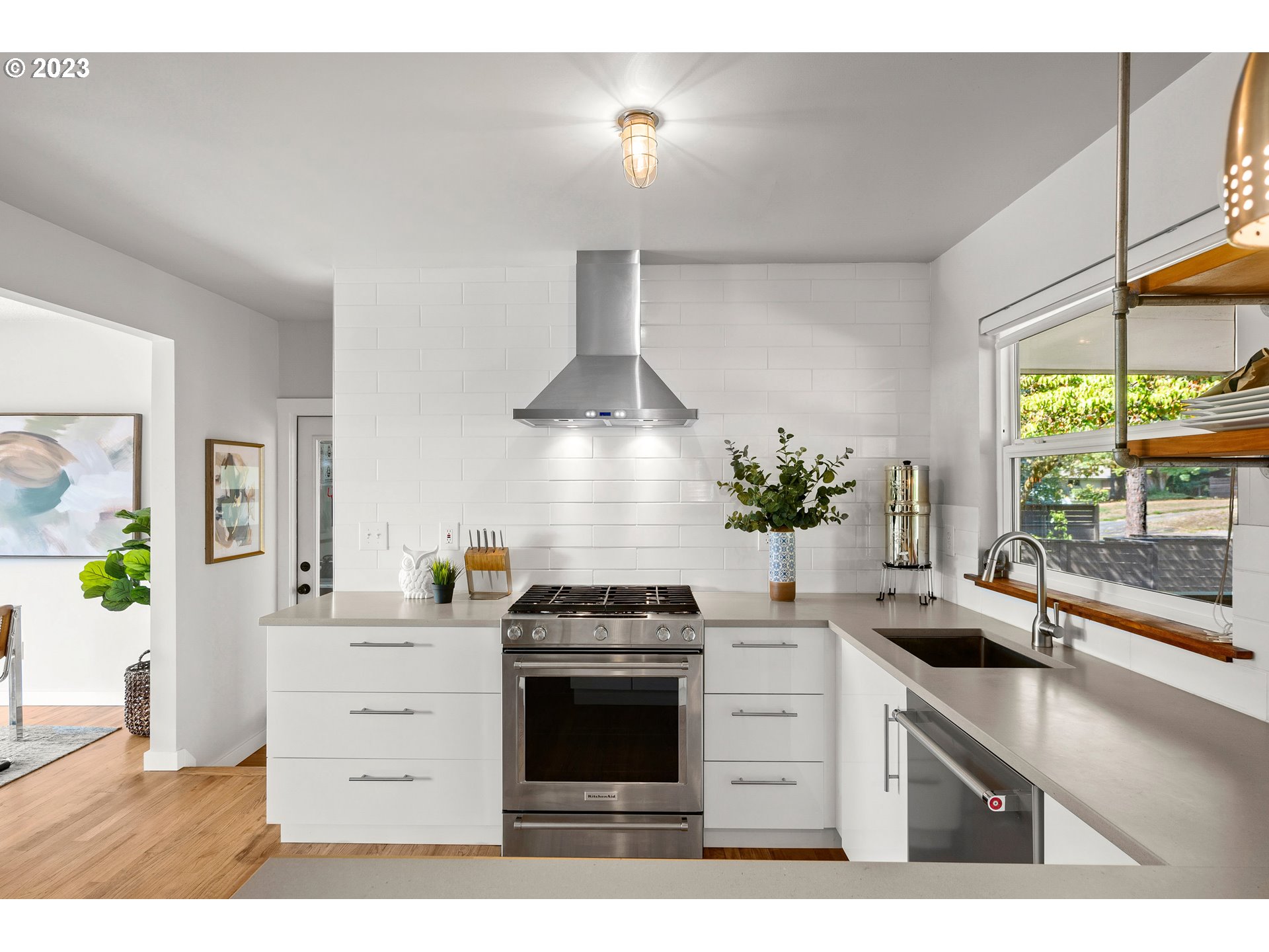 5914 Southwest Gunther Lane Portland, OR 97219 - Photo 12 of 40 a kitchen with a stove a sink and a potted plant