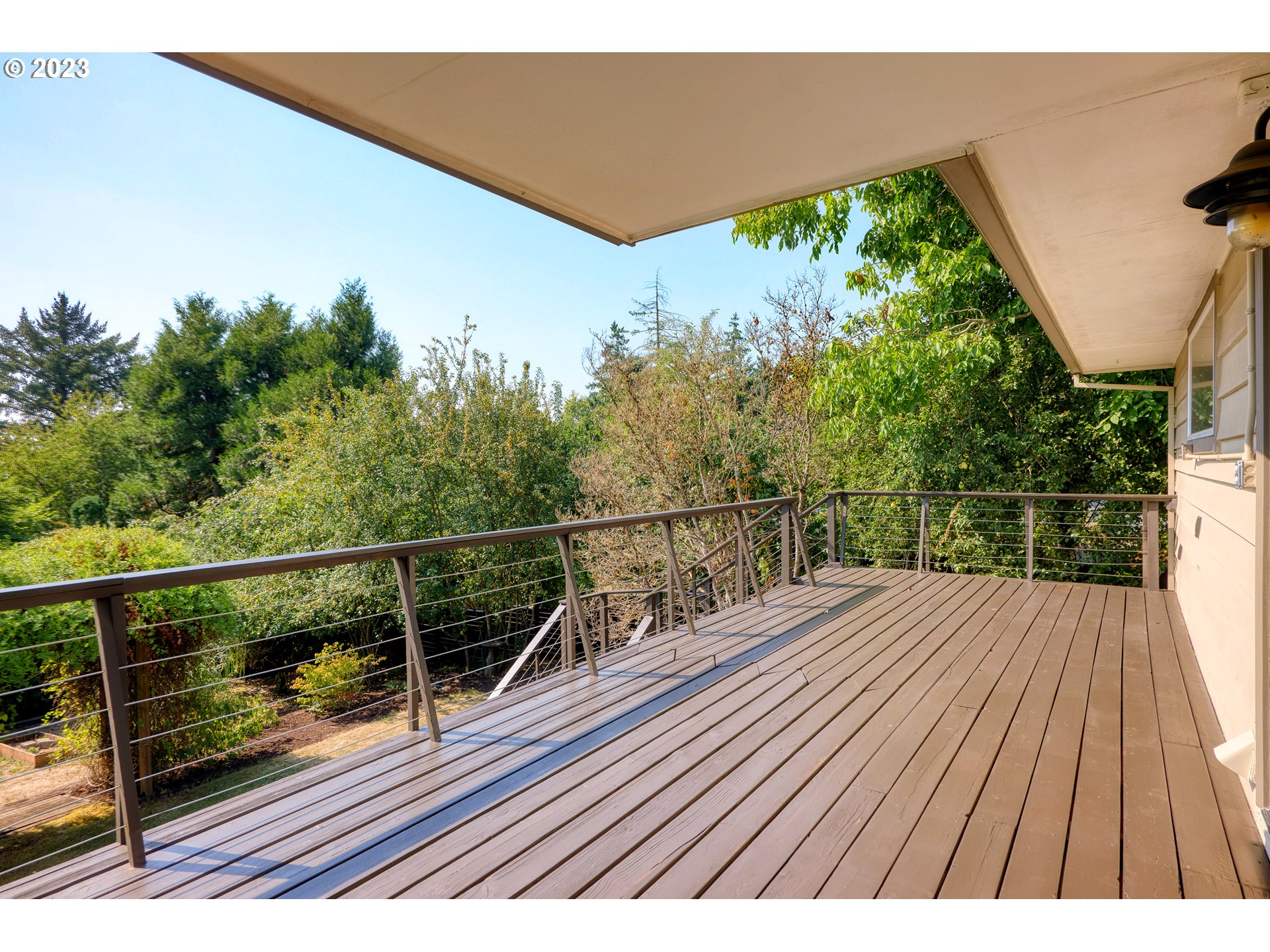 5914 Southwest Gunther Lane Portland, OR 97219 - Photo 16 of 40 a view of balcony with wooden floor and fence