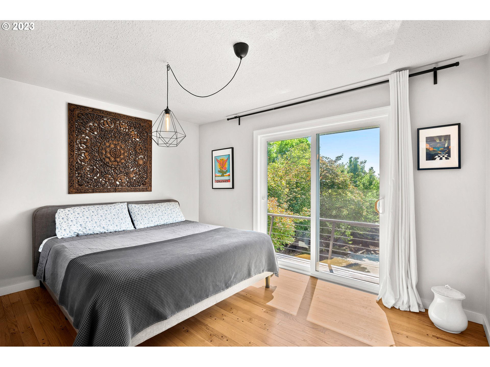 5914 Southwest Gunther Lane Portland, OR 97219 - Photo 17 of 40 a bedroom with a large bed and a window